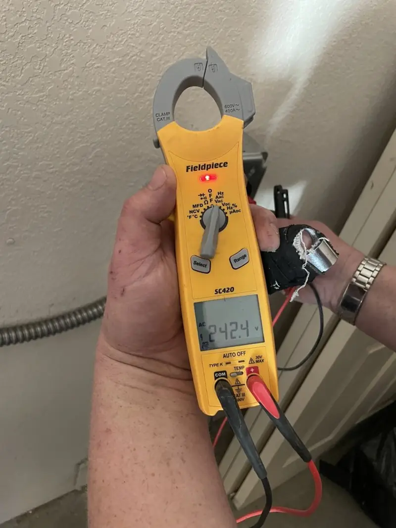 Voltage testing with clamp meter during Recessed Lighting Installation in Springfield